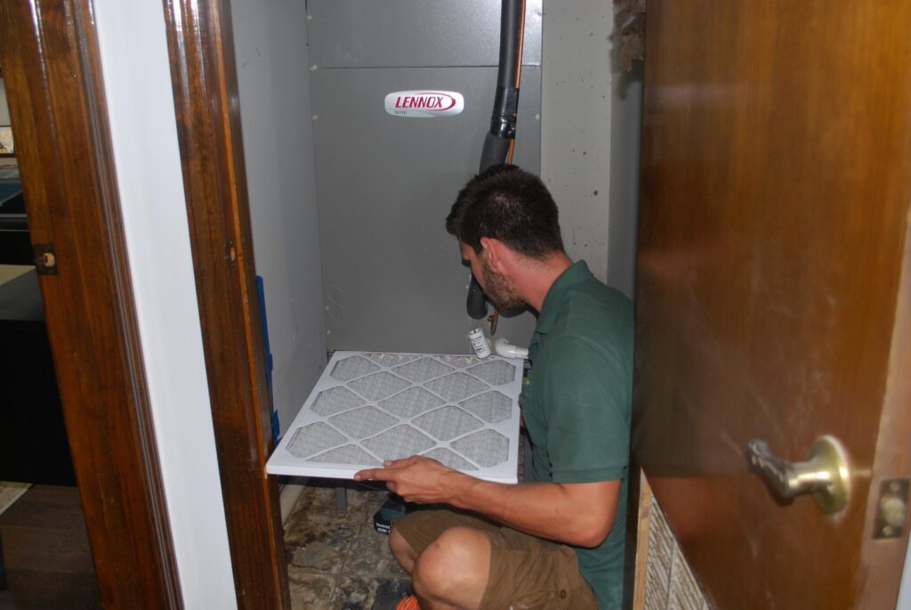 A technician holding a cleaned up filter