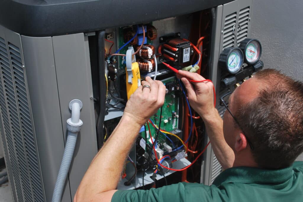 a technician doing HVAC check up