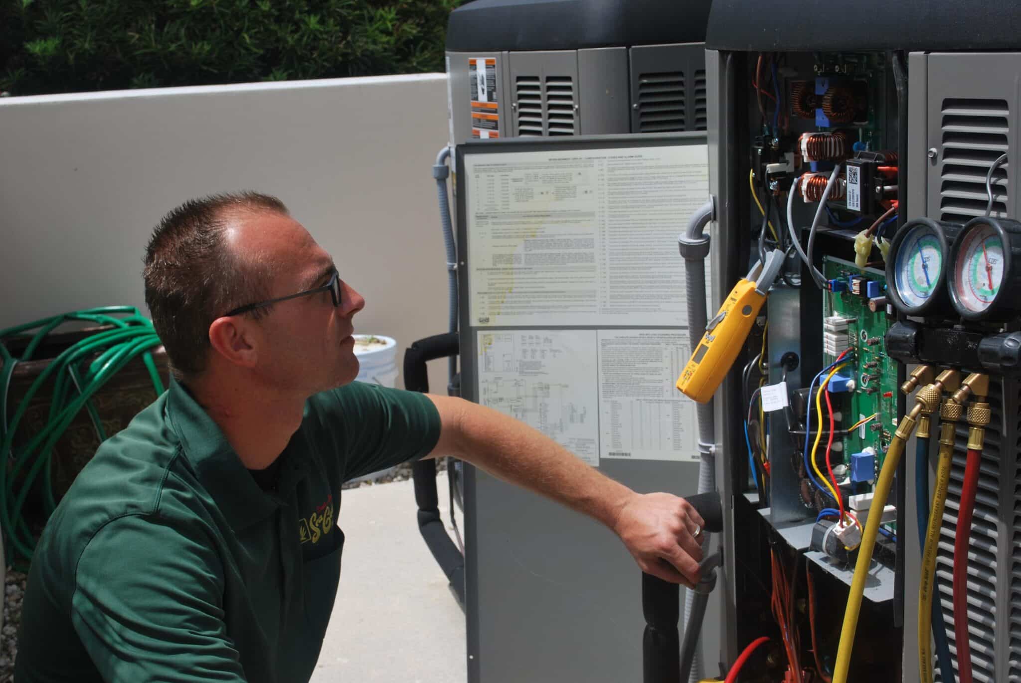 A technician checking up on the AC's functionality