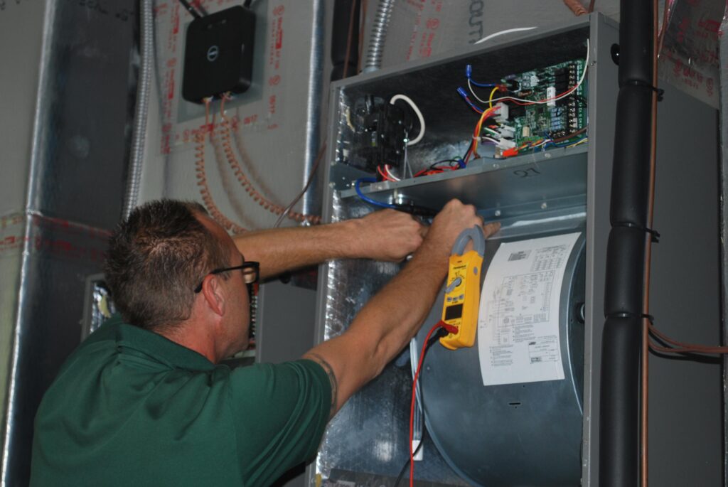 A technician tuning up air conditioner